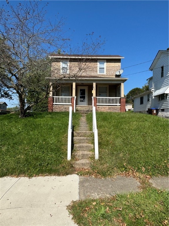 view of front facade featuring a front lawn and covered porch