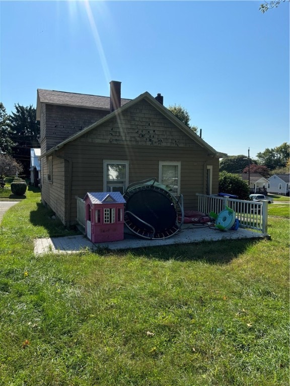 rear view of house with a yard