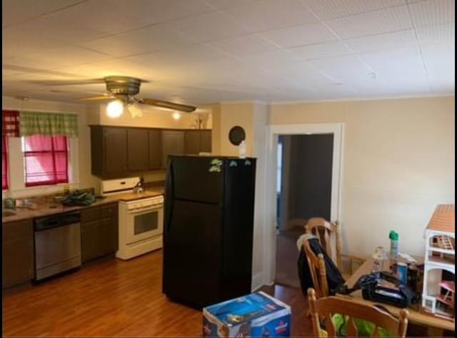 kitchen featuring ceiling fan, black refrigerator, dishwasher, white range oven, and hardwood / wood-style floors