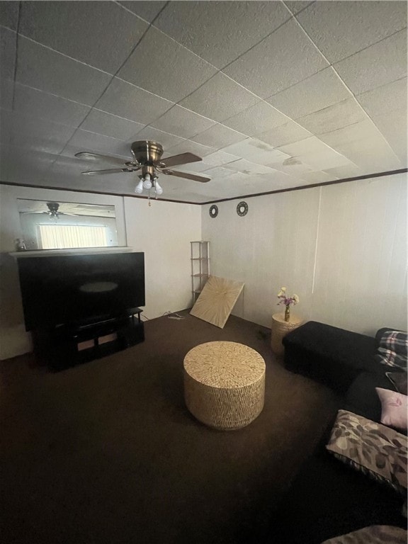 living room with ceiling fan and a paneled ceiling