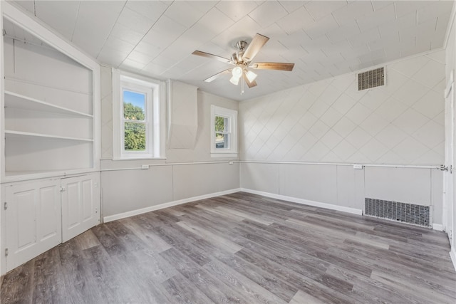 spare room featuring wood-type flooring and ceiling fan