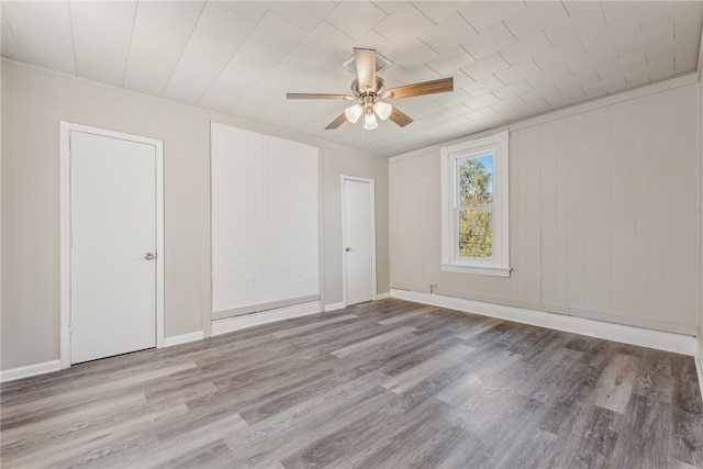 empty room with ceiling fan and light wood-type flooring