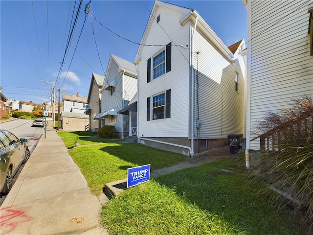 view of side of property with a yard