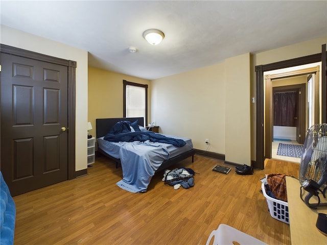 bedroom with wood-type flooring