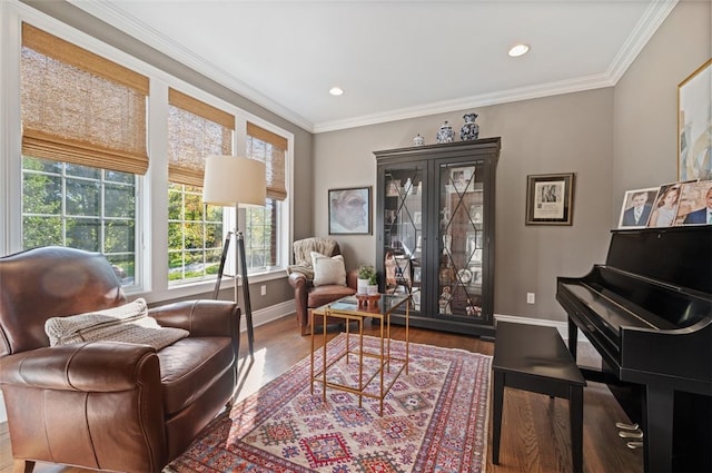 sitting room with hardwood / wood-style flooring, ornamental molding, and a wealth of natural light