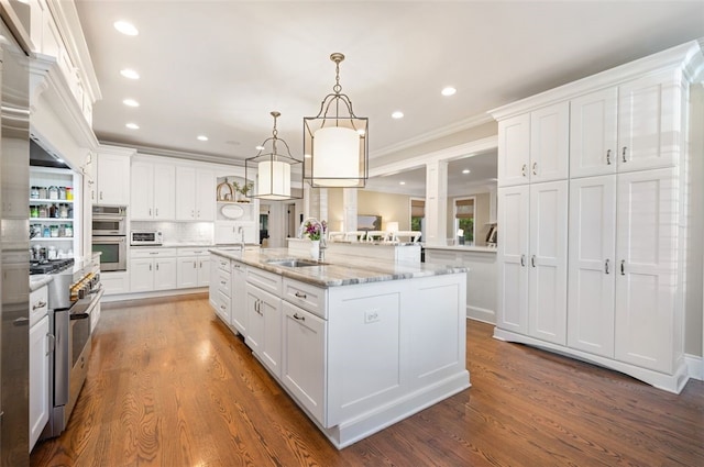 kitchen featuring white cabinetry, decorative light fixtures, and dark hardwood / wood-style flooring