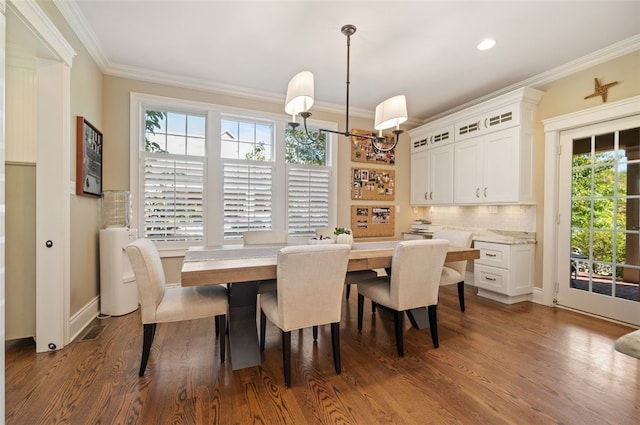 dining area with crown molding and dark hardwood / wood-style floors