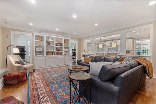 living room with crown molding and wood-type flooring