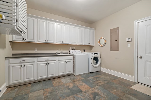 clothes washing area featuring sink, electric panel, washer and dryer, and cabinets