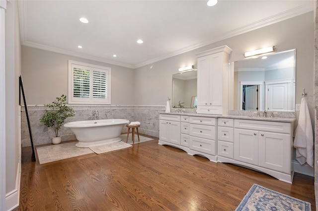 bathroom with vanity, tile walls, hardwood / wood-style flooring, and a bath