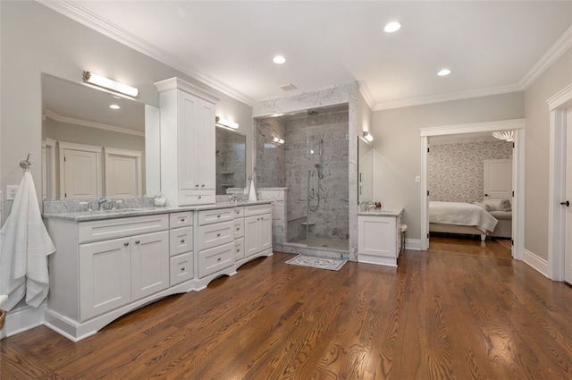 bathroom with a shower with door, crown molding, hardwood / wood-style floors, and vanity