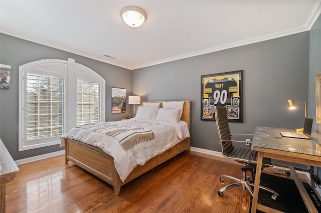 bedroom featuring ornamental molding and wood-type flooring