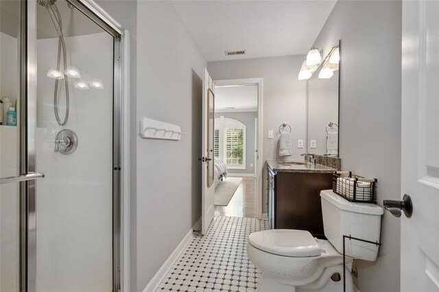 bathroom featuring toilet, walk in shower, and vanity