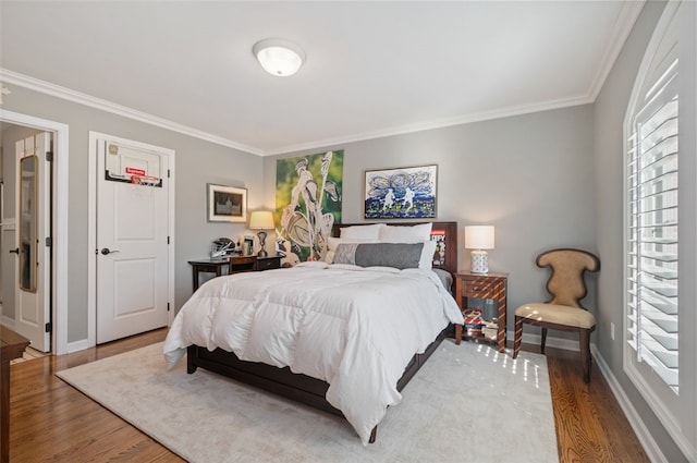 bedroom featuring wood-type flooring and ornamental molding