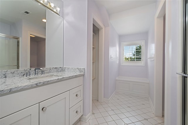 bathroom featuring vanity, tile patterned floors, and an enclosed shower