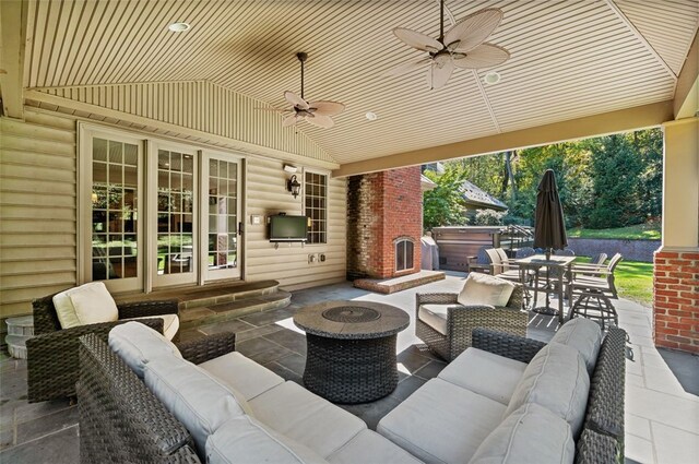 view of patio / terrace with a hot tub, an outdoor hangout area, french doors, and ceiling fan