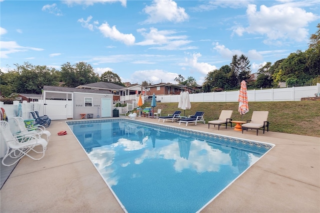 view of swimming pool featuring a lawn and a patio area