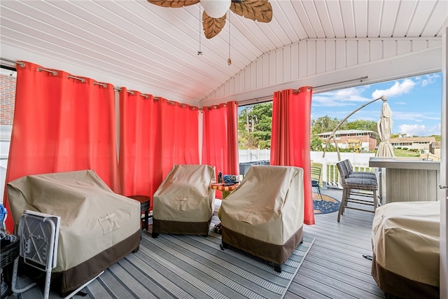 sunroom with lofted ceiling, wood ceiling, and ceiling fan