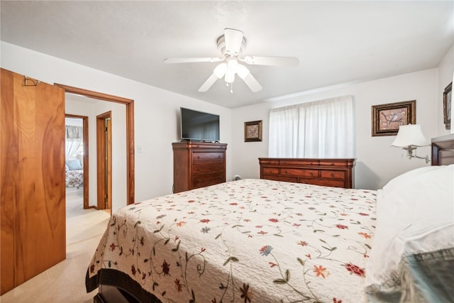 bedroom featuring light carpet and ceiling fan