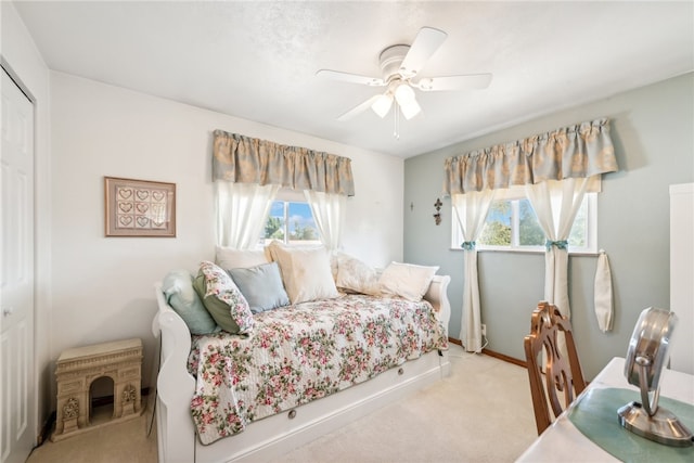 bedroom featuring ceiling fan, a closet, and multiple windows