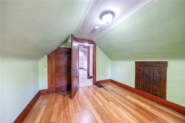 bonus room featuring vaulted ceiling and light hardwood / wood-style floors