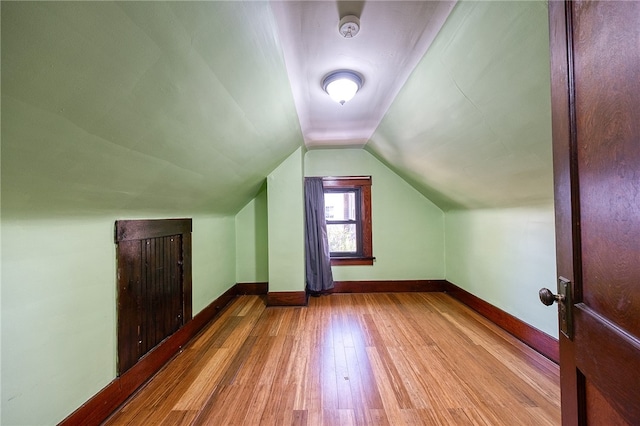 bonus room with vaulted ceiling and hardwood / wood-style floors