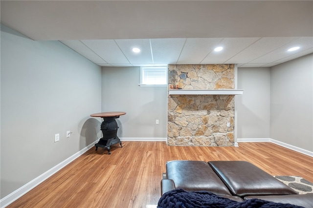 living area featuring a paneled ceiling and wood-type flooring