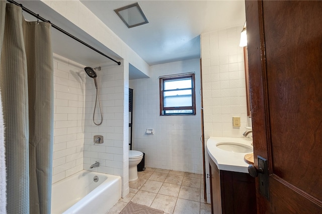 full bathroom featuring shower / tub combo, toilet, tile patterned floors, tile walls, and vanity