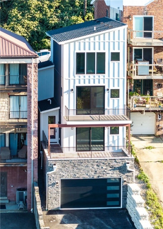 view of building exterior with central AC unit and a garage