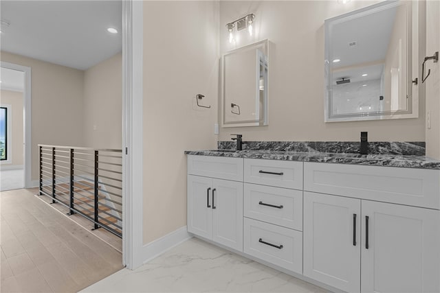 bathroom featuring vanity and a shower