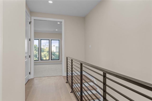 hallway with light hardwood / wood-style floors