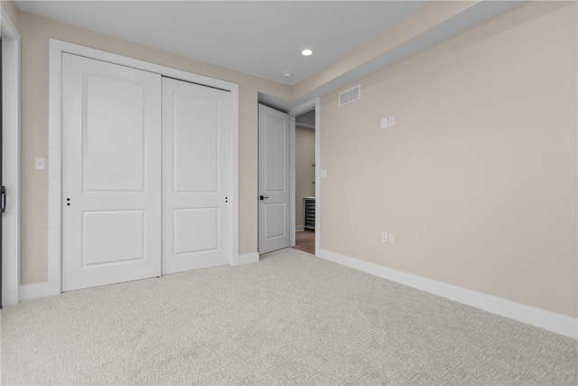 unfurnished bedroom featuring carpet floors and a closet