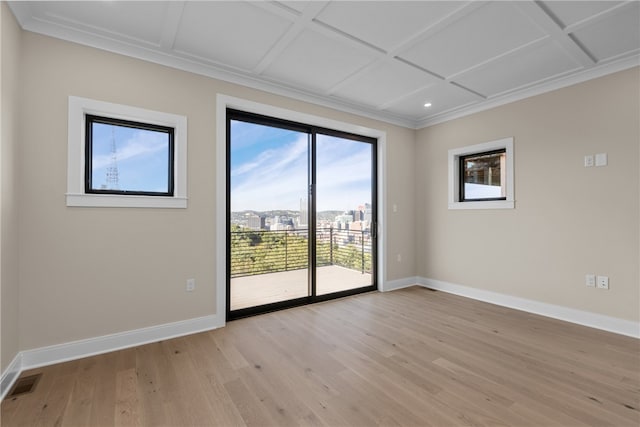 unfurnished room with ornamental molding, coffered ceiling, and light hardwood / wood-style flooring