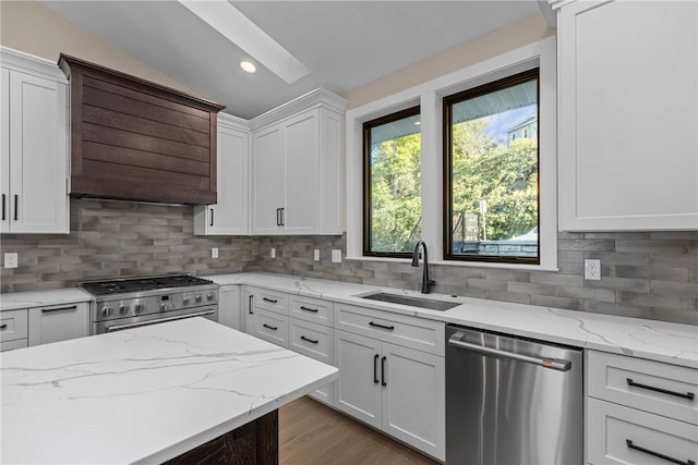 kitchen featuring tasteful backsplash, appliances with stainless steel finishes, sink, and white cabinetry