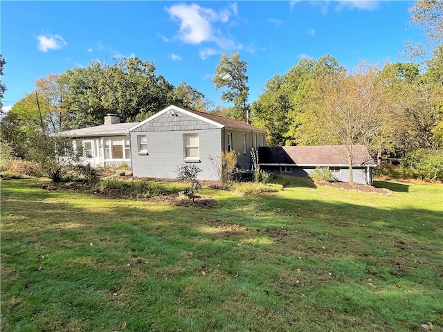 view of side of home featuring a yard