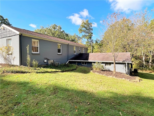 view of side of home with a lawn