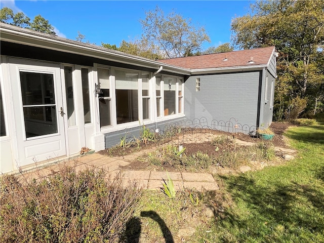 back of house featuring a sunroom