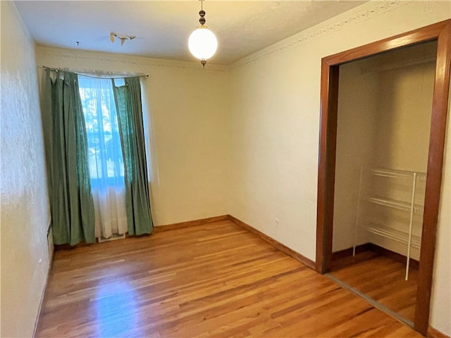 unfurnished bedroom with a closet and hardwood / wood-style floors