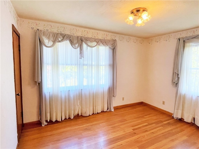 unfurnished room with hardwood / wood-style floors