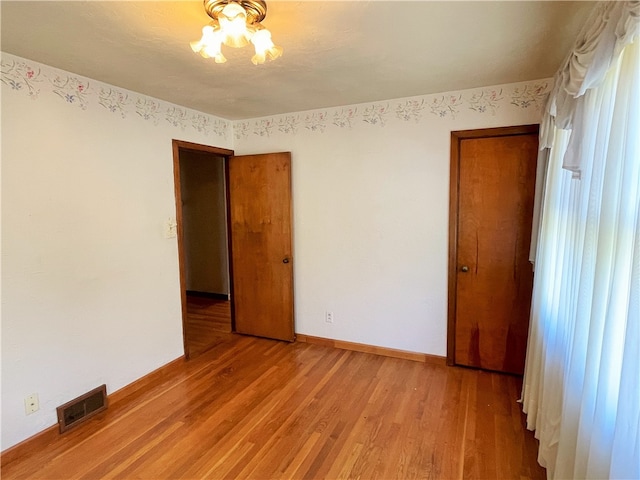 spare room featuring hardwood / wood-style flooring