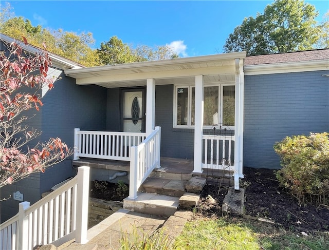 doorway to property featuring covered porch