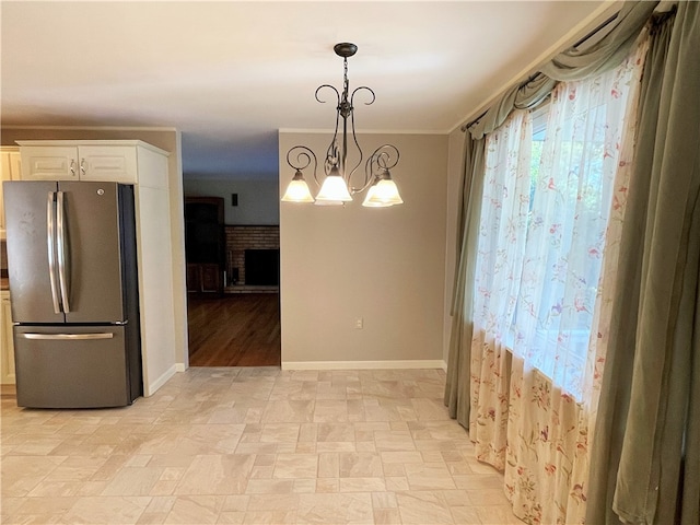 unfurnished dining area with a brick fireplace