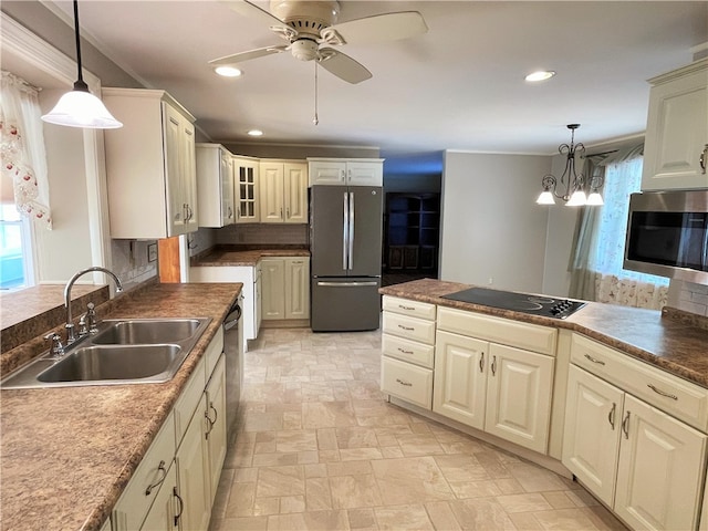 kitchen featuring decorative backsplash, hanging light fixtures, appliances with stainless steel finishes, and sink