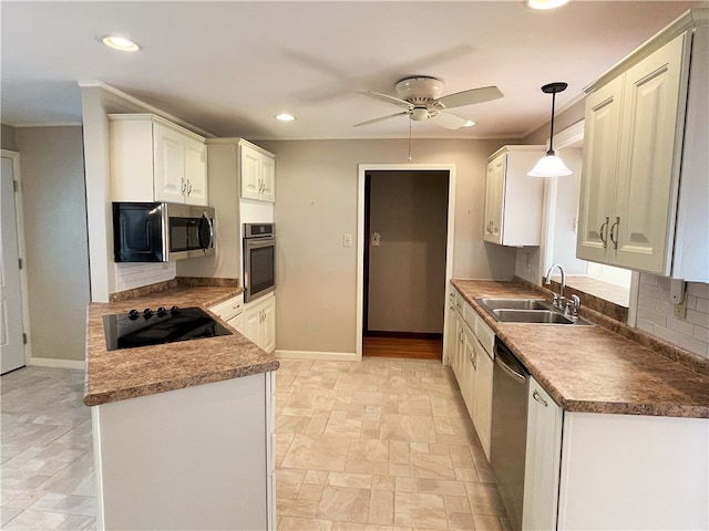 kitchen featuring white cabinets, sink, decorative light fixtures, backsplash, and stainless steel appliances