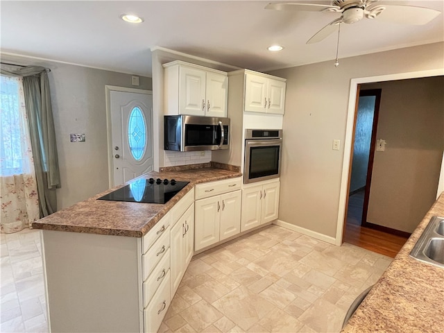 kitchen with ceiling fan, appliances with stainless steel finishes, sink, and white cabinetry