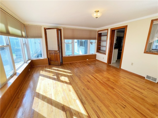 interior space with crown molding and wood-type flooring