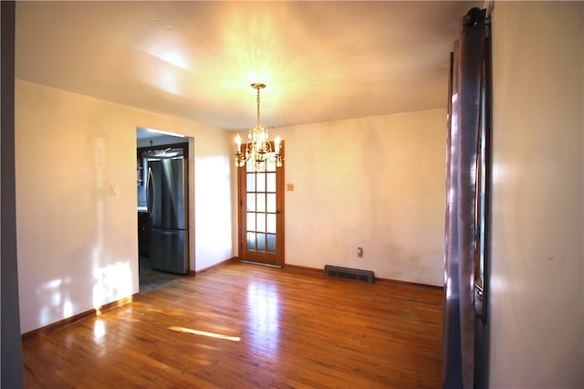 76 Broad St, West Bethlehem, PA 15345 - unfurnished dining area with wood finished floors, visible vents, baseboards, and a notable chandelier
