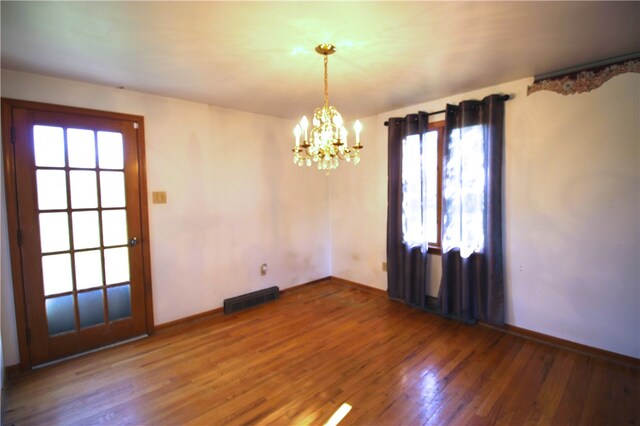 76 Broad St, West Bethlehem, PA 15345 - unfurnished room with an inviting chandelier, wood finished floors, visible vents, and baseboards