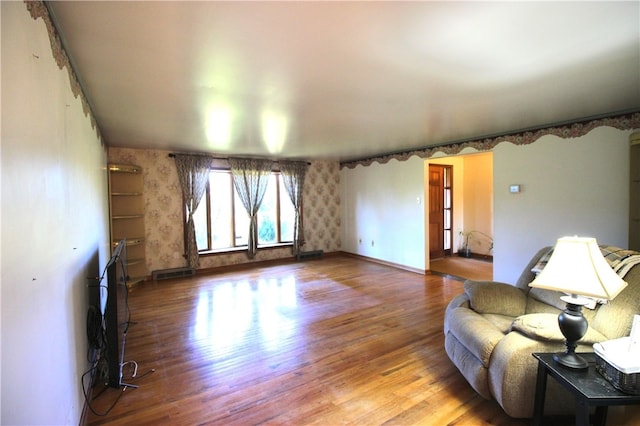 76 Broad St, West Bethlehem, PA 15345 - living area featuring wallpapered walls, wood finished floors, visible vents, and baseboards