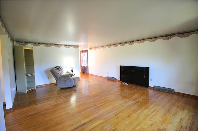 unfurnished room with light hardwood / wood-style flooring